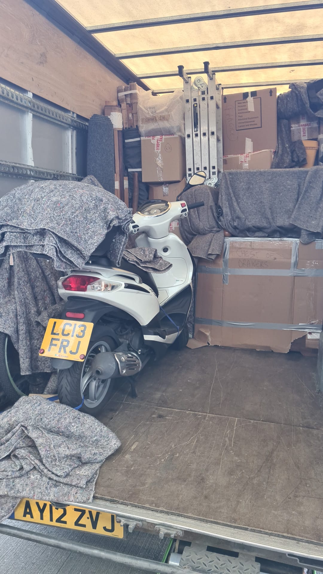 Fully loaded Transcone truck with scooter and household goods securely packed for international move