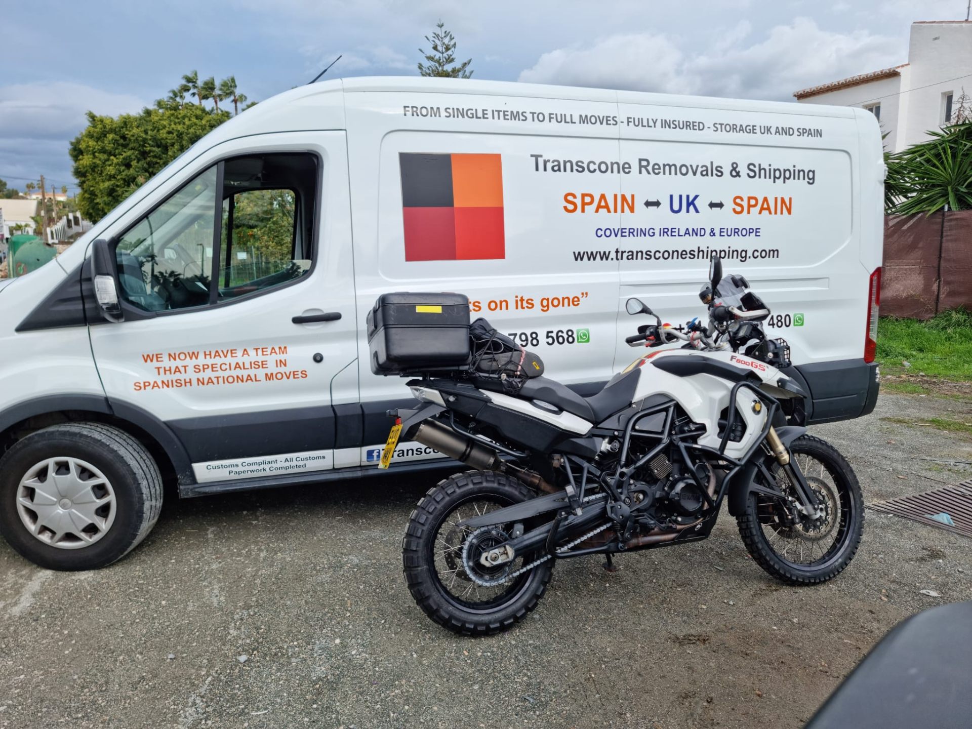 Transcone branded van with motorbike ready for small vehicle transport between Spain and UK